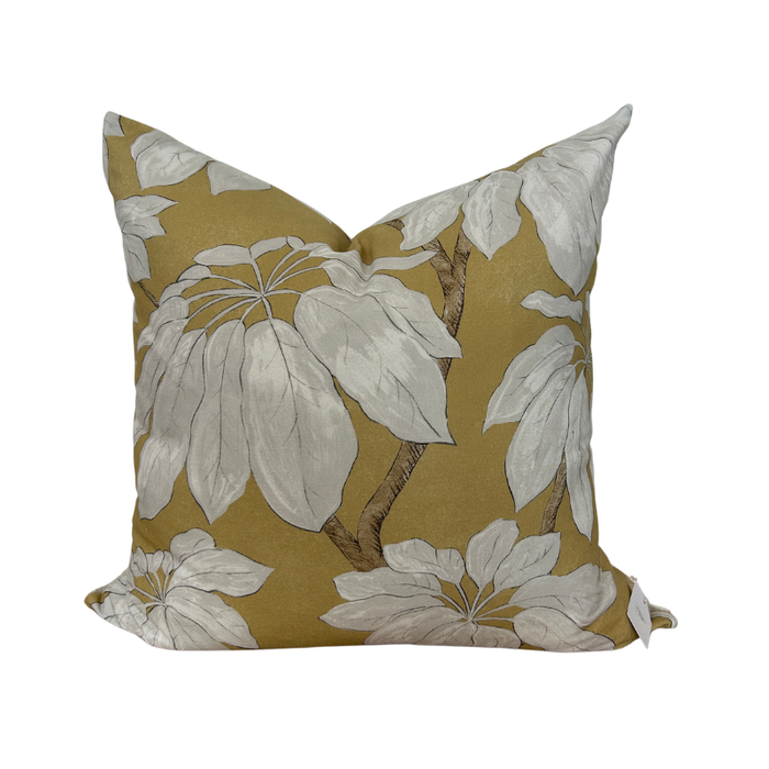 Floral-patterned pillow with white flowers on a yellow background