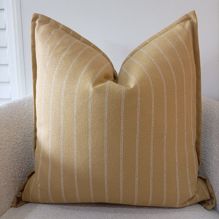 Mustard gold scatter cushion featuring thin white vertical pinstripes on a textured linen-blend fabric.