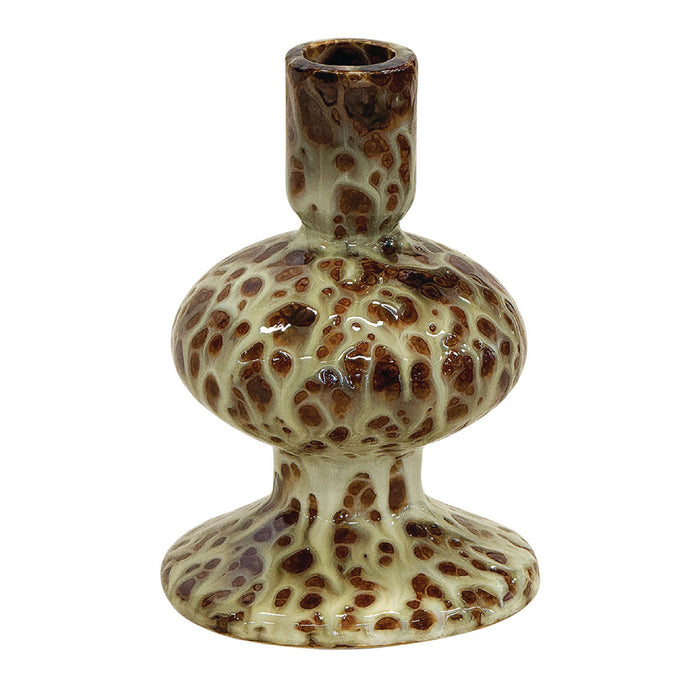 Ceramic candle holder with brown speckles on a white background
