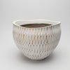 A wide, rounded polyresin planter pot with a wavy rim, decorated in an embossed white and earthy brown geometric stripe pattern.