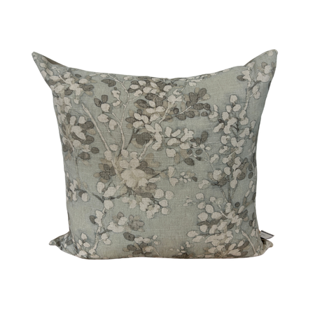 Decorative pillow with floral pattern on a light green background