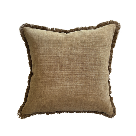 Brown textured pillow with frayed edges on a white background