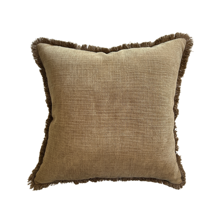 Brown textured pillow with frayed edges on a white background