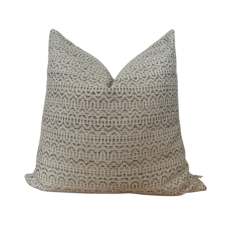 Textured pillow with geometric pattern on a white background